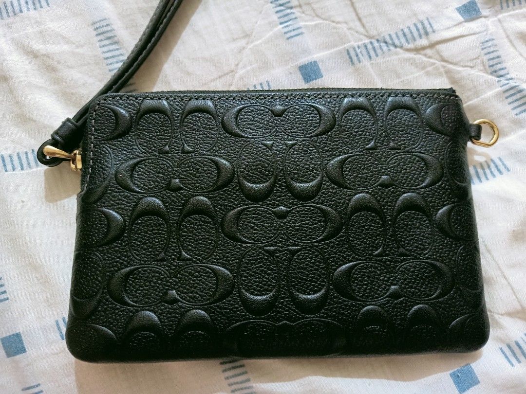 Coach Black Wristlet (Category: Luxury Bags & Wallets) located in Angeles City. Submitted by ejhere (Listing ID 1399380421, Image 2). Description: - Black Coach Wristlet - Embossed Coach logo pattern - Zip-around closure - Wrist strap included - Multiple card slots inside - Gold-toned hardware 🔻COURIER: J&T 🔻SHIPPING FEE TO BE SHOULDERED BY THE BUYER *Estimated min Shipping Fee within Luzon Php58 ‼️FOR SURE BUYER ONLY PLEASE‼️ ❣️LAST PRICE POST