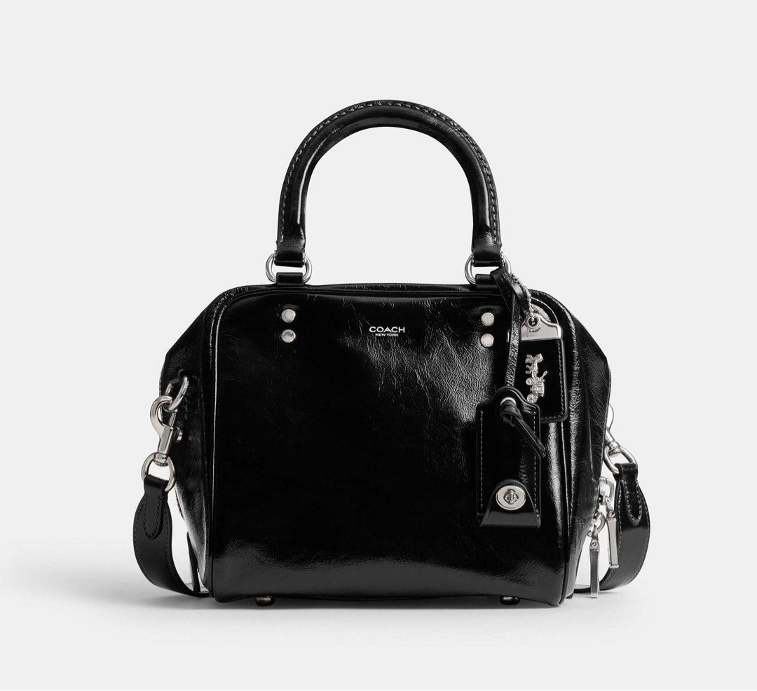Coach Cube Rogue Bag 20 (Category: Cross-body Bags) located in Marikina City. Submitted by smthxtra (Listing ID 1399421577, Image 1). Description: Length: 8.0” Height: 7.0” Width: 7.0” Glazed leather Fabric lining Handles with 4” drop Detachable strap with 21.5” drop for shoulder or crossbody wear Outside zip pocket Inside zip pocket Zip closure Four protective feet at base With tag, care card, dust bag, and paper bag.