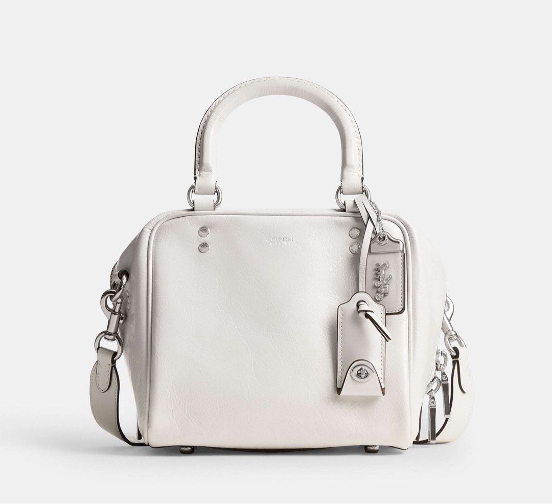 Coach Cube Rogue Bag 20 (Category: Cross-body Bags) located in Marikina City. Submitted by smthxtra (Listing ID 1399421755, Image 2). Description: Length: 8.0” Height: 7.0” Width: 7.0” Glazed leather Fabric lining Handles with 4” drop Detachable strap with 21.5” drop for shoulder or crossbody wear Outside zip pocket Inside zip pocket Zip closure Four protective feet at base With tag, care card, dust bag, and paper bag.