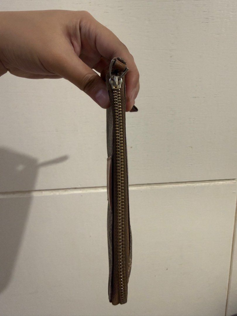Coach Signature Wristlet (Category: Luxury Bags & Wallets) located in Angeles City. Submitted by percydlr (Listing ID 1399346675, Image 2). Description: - Coach wristlet with signature pattern - Zip closure - Wrist strap included - Multiple card slots inside - Made in Vietnam - Color: Brown with brown leather accent Minimal issue on the strap but the rest is good. Signs of usage and needs cleaning due to storage. Please manage your expectations. 