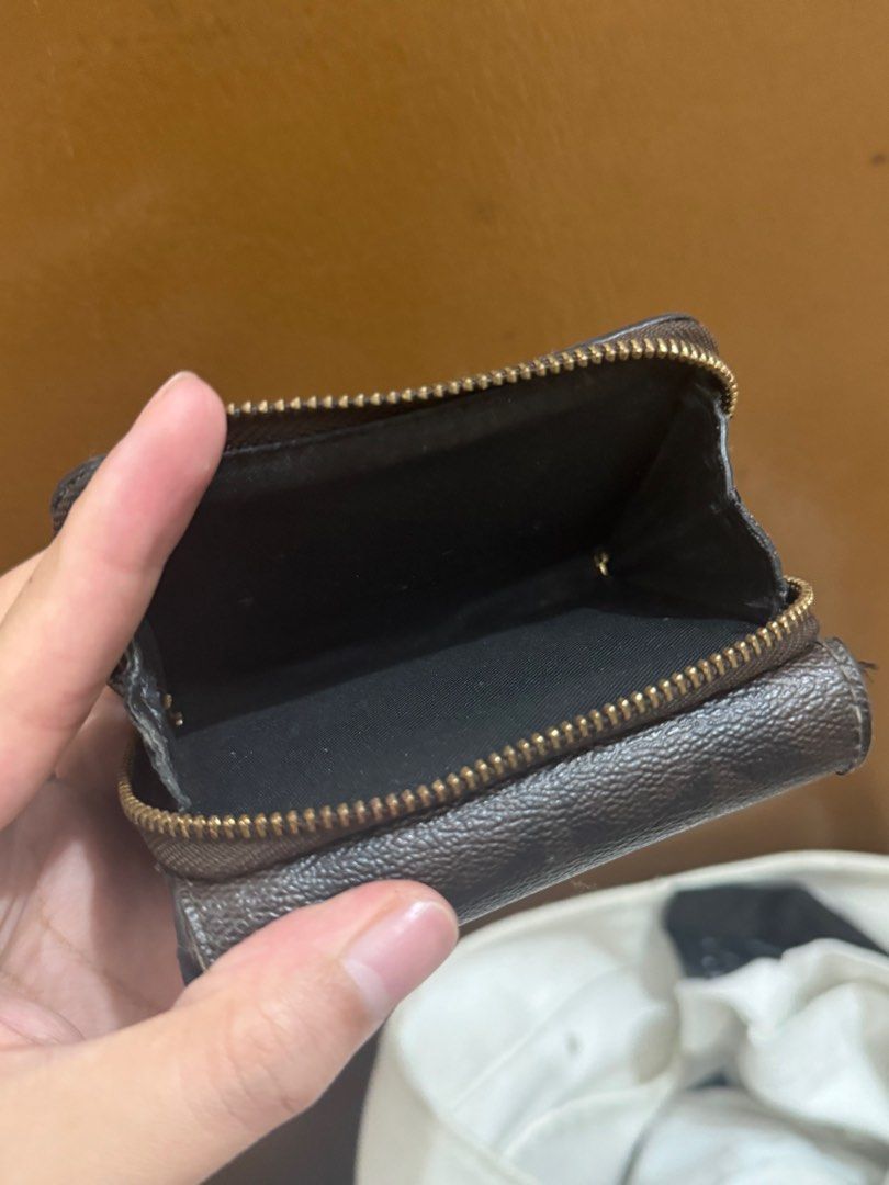 Coach Trifold Wallet (Category: Wallets & Card holders) located in Taguig. Submitted by bncdnc (Listing ID 1399334489, Image 3). Description: - Authentic Coach trifold wallet - Brown exterior with Coach logo - Black interior - Multiple card slots - ID window - Zip-around coin compartment - Snap closure - Gold-toned zipper.