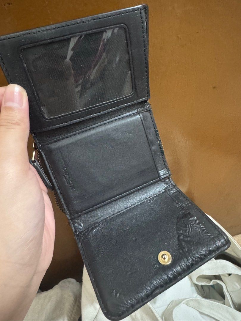 Coach Trifold Wallet (Category: Wallets & Card holders) located in Taguig. Submitted by bncdnc (Listing ID 1399334489, Image 1). Description: - Authentic Coach trifold wallet - Brown exterior with Coach logo - Black interior - Multiple card slots - ID window - Zip-around coin compartment - Snap closure - Gold-toned zipper.