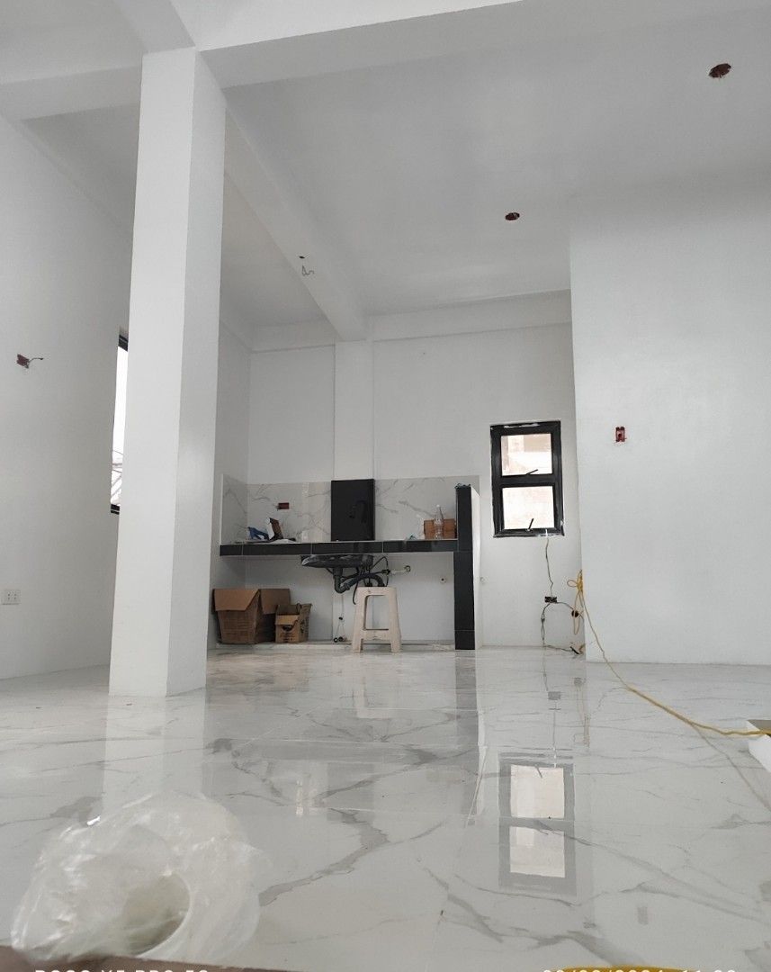 For rent commercial space include water station (Category: Apartments & Condos) located in Caloocan City. Submitted by latrinaavi (Listing ID 1399309636, Image 2). Description: Commercial space available for lease. Features a modern interior with a kitchen area and ample open space. The exterior showcases a blue facade with a storefront, suitable for various business types. Includes a waiting area and a clean, well-lit environment. Perfect for es