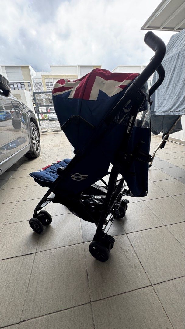 Easywalker Mini Stroller (Category: Strollers) located in Shah Alam. Submitted by bbball (Listing ID 1399337849, Image 3). Description: - Easywalker Mini stroller - Navy blue with Union Jack design - Black frame - Compact and lightweight - Padded seat - Sunshade - Curved handle for easy maneuvering - Suitable for travel.