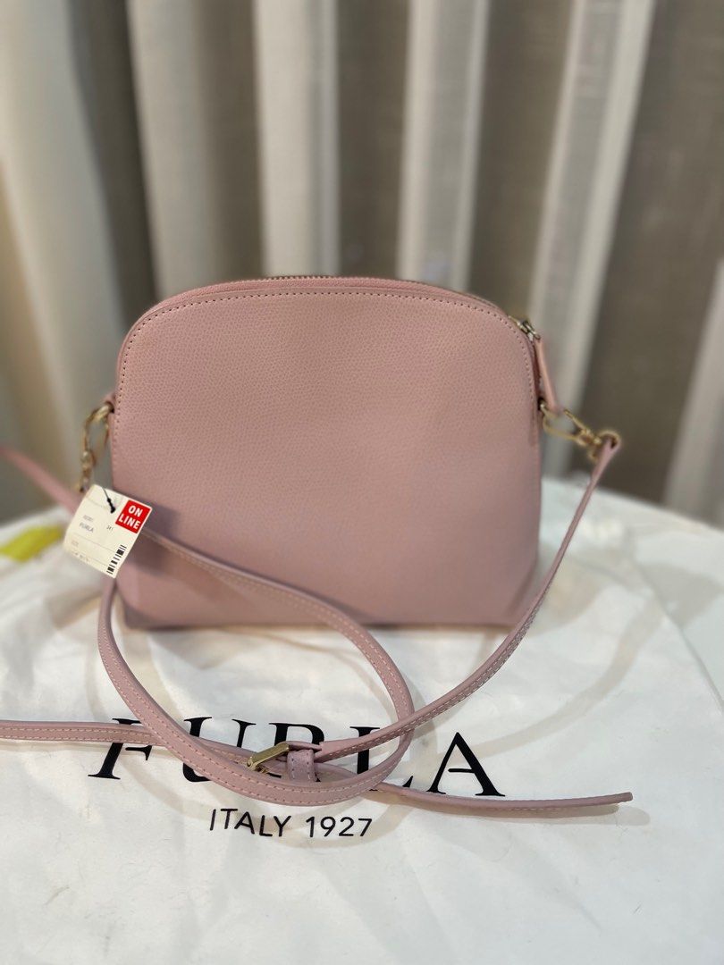 Furla Metropolis Mini Crossbody Bag (Category: Luxury Bags & Wallets) located in Makati City. Submitted by triftedandbranded (Listing ID 1399383968, Image 3). Description: - Authentic Furla Metropolis Mini crossbody bag - Soft pink color - Top zip closure - Gold-tone hardware - Detachable shoulder strap - Main compartment and slip pocket - Includes dust bag - Original tags.