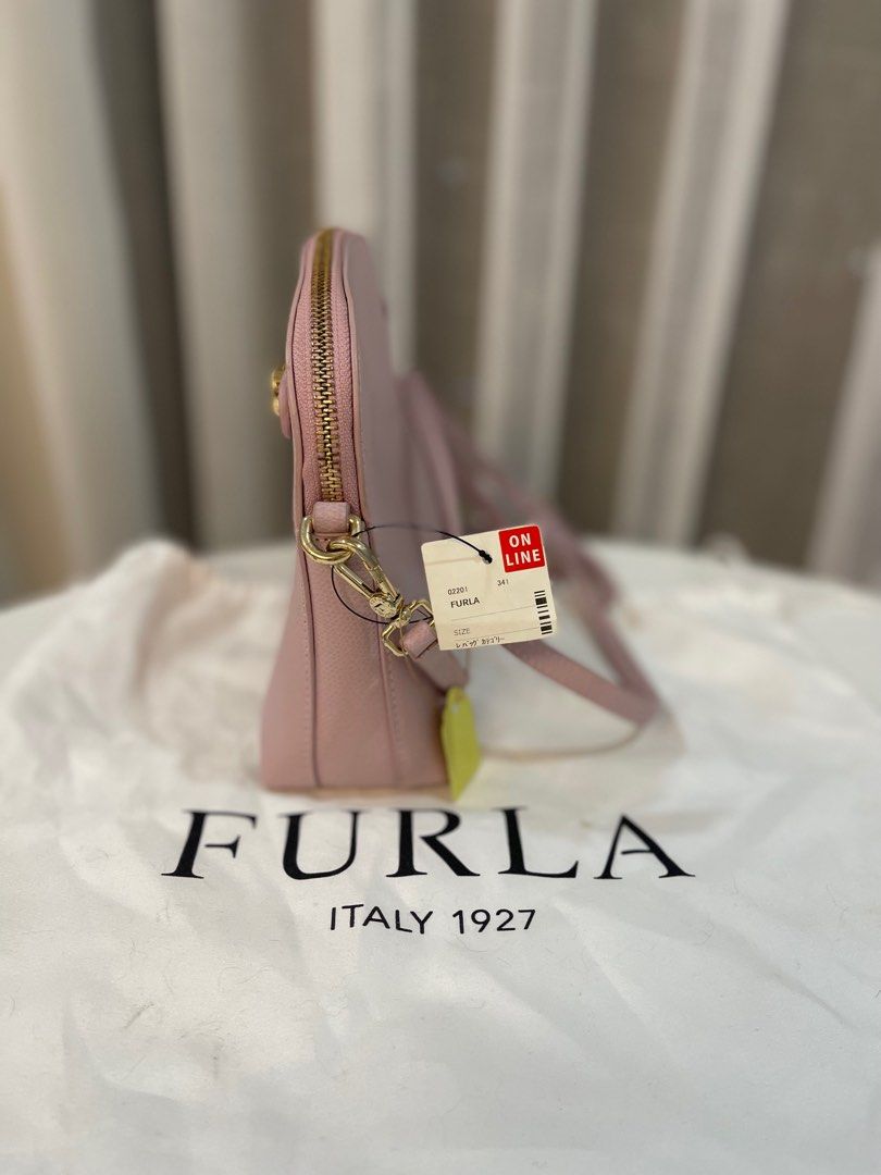 Furla Metropolis Mini Crossbody Bag (Category: Luxury Bags & Wallets) located in Makati City. Submitted by triftedandbranded (Listing ID 1399383968, Image 2). Description: - Authentic Furla Metropolis Mini crossbody bag - Soft pink color - Top zip closure - Gold-tone hardware - Detachable shoulder strap - Main compartment and slip pocket - Includes dust bag - Original tags.
