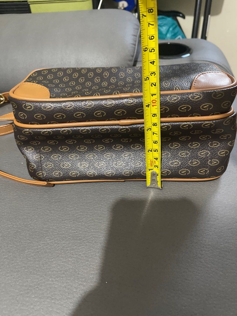 Gianni Valentino Brown Shoulder Bag (Category: Luxury Bags & Wallets) located in San Juan City. Submitted by nhelsky_c (Listing ID 1399350803, Image 3). Description: - Gianni Valentino shoulder bag - Brown and tan color scheme with 'V' pattern - long shoulder strap - Multiple compartments - Gold-toned zippers - Dark brown interior lining - Small interior pocket - Dimensions: Approximately 10 inches (length) x 8 inches (height).