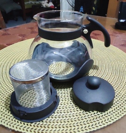 Glass Teapot with Infuser (Category: Coffee & Tea Tableware) located in Las Pinas. Submitted by lawki_stuff (Listing ID 1399385567, Image 1). Description: Glass teapot with stainless steel infuser, lid, and black accents. Measurement approx - 12cm x15cm Not for stove, oven or microwave use.