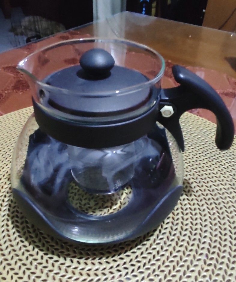 Glass Teapot with Infuser (Category: Coffee & Tea Tableware) located in Las Pinas. Submitted by lawki_stuff (Listing ID 1399385567, Image 2). Description: Glass teapot with stainless steel infuser, lid, and black accents. Measurement approx - 12cm x15cm Not for stove, oven or microwave use.