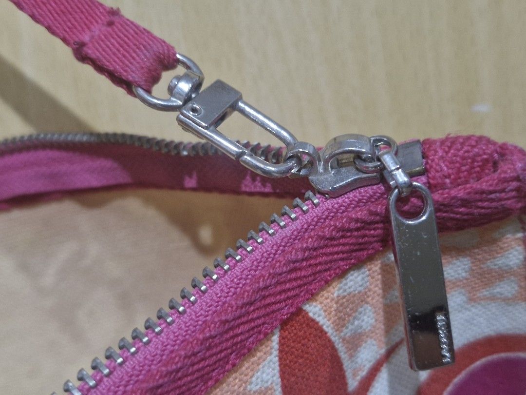 LACOSTE Floral Clutch with Wrist Strap (Category: Clutches) located in Muntinlupa City. Submitted by kmrod (Listing ID 1399356142, Image 3). Description: Stylish floral clutch with pink accents. Features a zipper, wrist strap, and brand detail. Made of sturdy fabric. part of a bag with the same design stored for a while so needs cleaning 9x5 inches.
