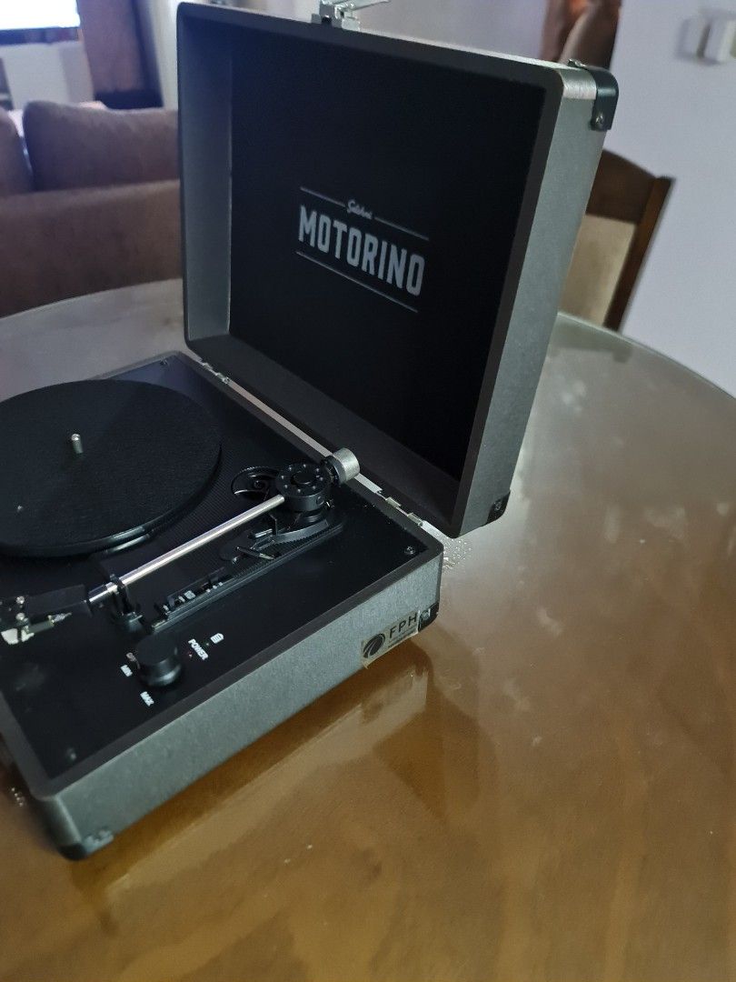 Motorino Suitcase Record Player with Vinyl Records (Category: Portable Music Players) located in Mandaluyong City. Submitted by jldo28 (Listing ID 1399443854, Image 3). Description: - Motorino suitcase record player - Built-in speakers - Includes vinyl records (Frank Sinatra, Jo Stafford, and more) - Portable design with a handle - Features DC 12V input - RCA output and line in ports - In good working condition.