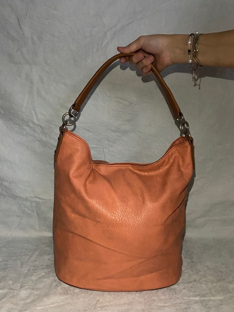 Orange Hobo Bag with Brown Straps (Category: Shoulder Bags) located in Rizal. Submitted by protractor (Listing ID 1399332056, Image 2). Description: ⭐️ Pre-loved ⭐️ Small ⭐️ In Very Good condition Location: Taytay Rizal Payment: GCASH SF: shoulder by buyer Send a PM for more pictures and info! ✨Stylish orange hobo bag ✨Brown straps ✨Textured material.
