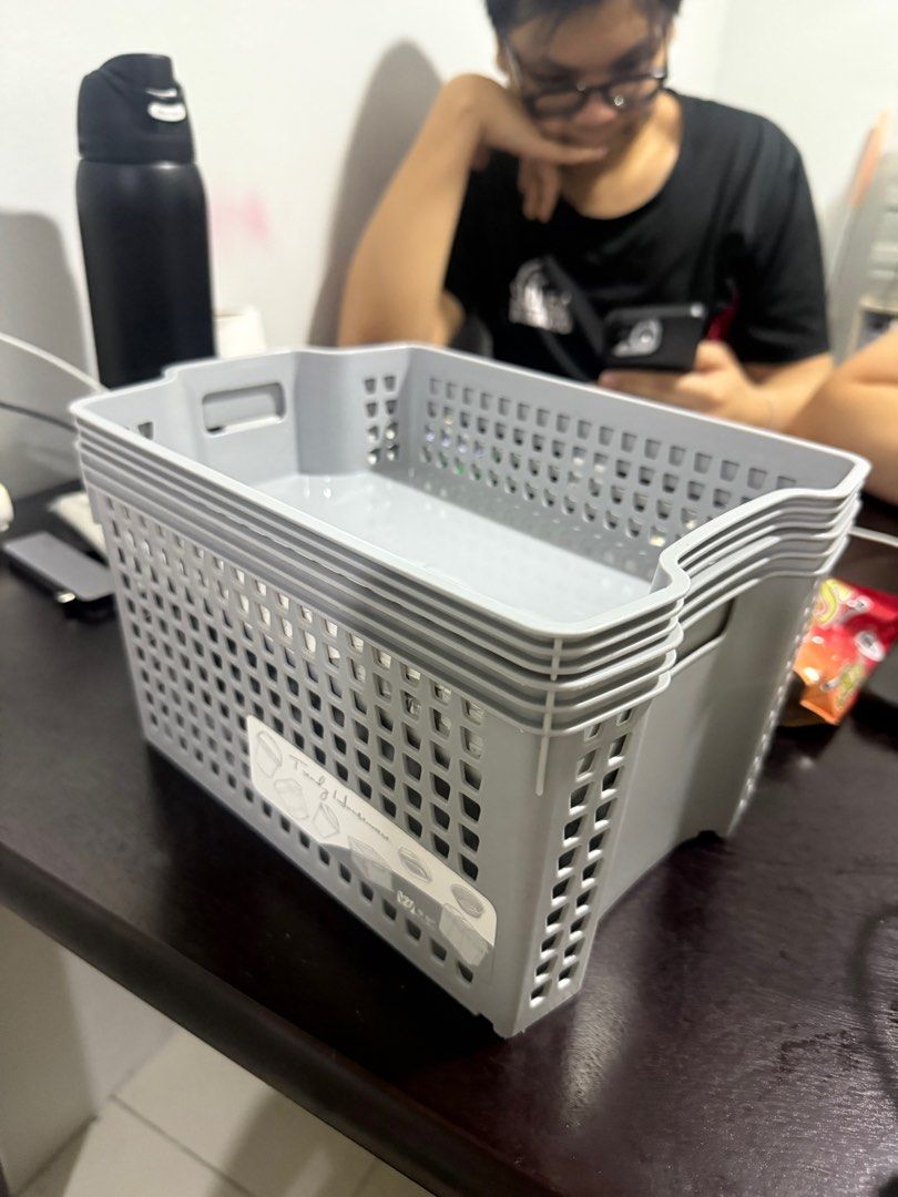 Stackable Storage Basket Grey (Category: Storage Boxes & Baskets) located in Manila. Submitted by caitlinmoon (Listing ID 1399393636, Image 1). Description: - Set of stackable storage baskets - Color: Gray - Shape: Rectangular - Design: Perforated - Material: Plastic - Ideal for organizing various items - Space-saving design.