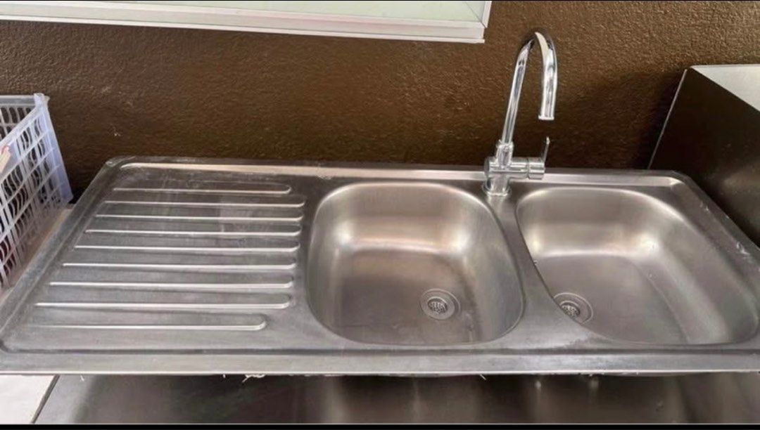 Stainless Steel Double Bowl Kitchen Sink (Category: Bathroom & Kitchen Fixtures) located in Quezon City. Submitted by tinylee60 (Listing ID 1399443850, Image 2). Description: - Stainless steel double bowl kitchen sink - Includes built-in drainboard - Comes with a chrome faucet - Features two basins for convenience - Ideal for kitchen use.