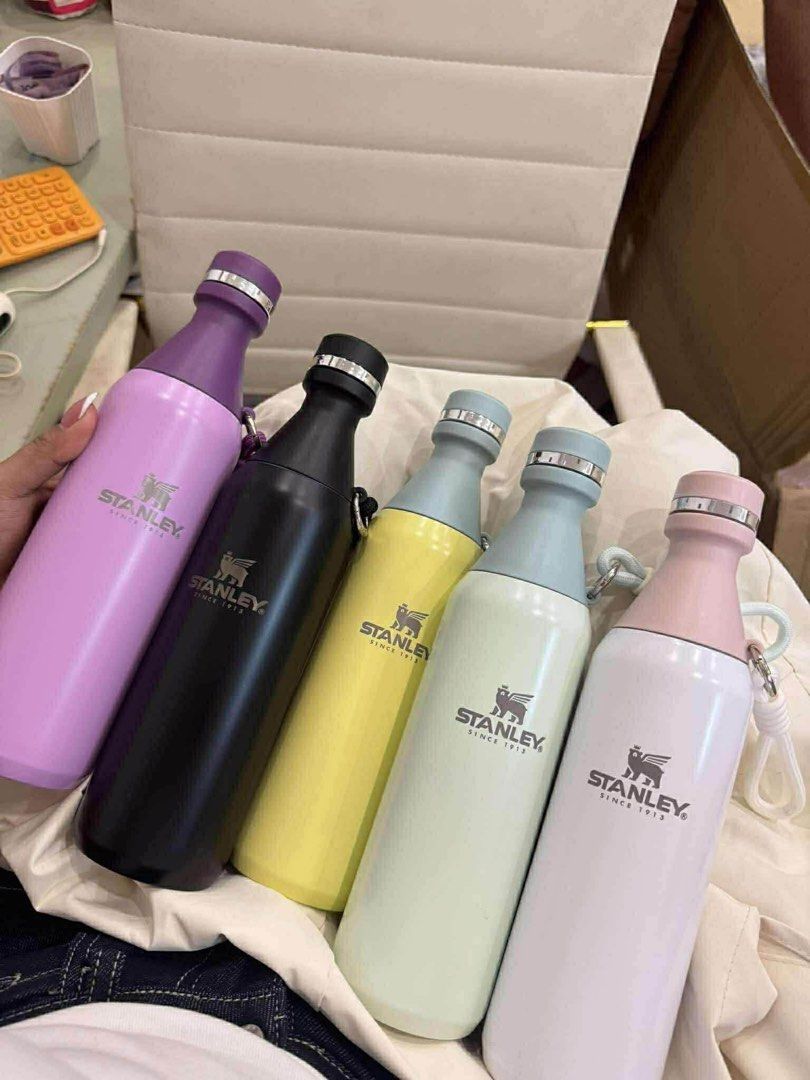 Stanley Water Bottle (Category: Water Bottles & Tumblers) located in Quezon City. Submitted by stuffs.hellyy (Listing ID 1399408892, Image 1). Description: - Stanley water bottles in various colors: purple, black, yellow, white, and pink. - Screw-on cap with a handle for easy carrying. - Features the Stanley logo. - Insulated design..