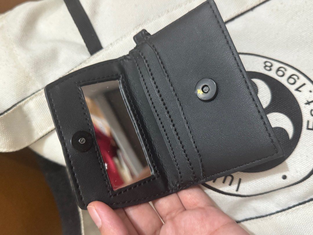 Steve Madden Black Wallet with Mirror (Category: Wallets & Card holders) located in Taguig. Submitted by bncdnc (Listing ID 1399335215, Image 2). Description: - Black Steve Madden wallet - Compact design - Includes a small mirror - Multiple compartments for cards and cash - Snap closure - Features a small loop - Steve Madden logo visible.