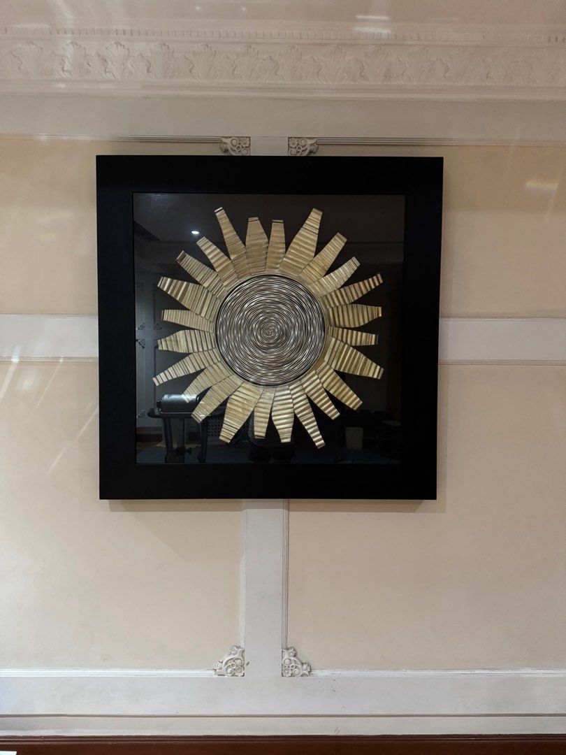 Sunburst Wall Art (Category: Wall Decor) located in Quezon City. Submitted by tinylee60 (Listing ID 1399444547, Image 1). Description: - Unique sunburst wall art - Circular design with radiating elements - Features a spiral center - Black frame - Ready to hang - Adds artistic flair to any living space - Instantly elevates your home decor.