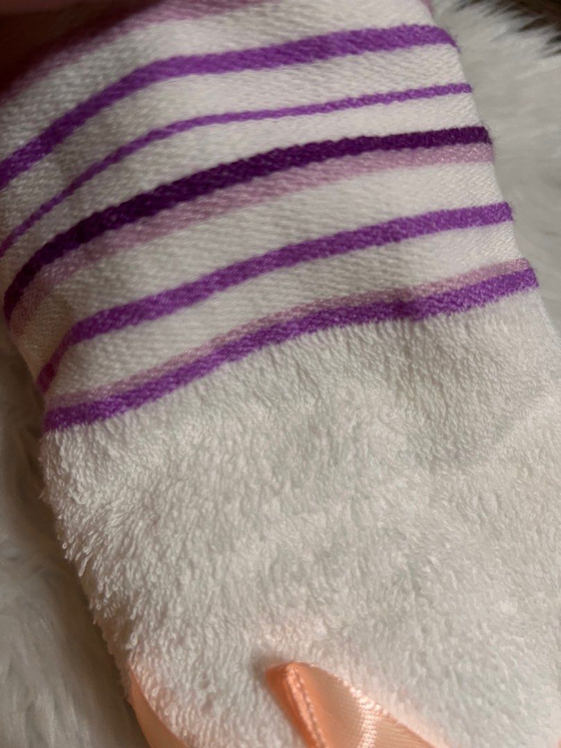 White Towel with Purple Stripes (Category: Bedding & Towels) located in Lubao. Submitted by mioreecollection (Listing ID 1399385349, Image 2). Description: - Soft white towel - Purple striped edge - Tied with a peach ribbon - Unused and clean - Ideal for personal use or as a gift - Made of absorbent material.
