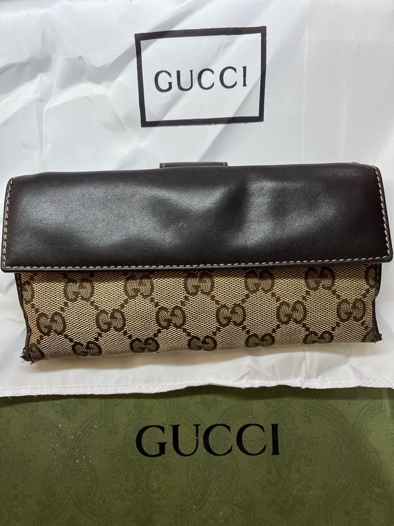 💯% Gucci GG Canvas Wallet (Category: Luxury Bags & Wallets) located in Pasig City. Submitted by ceirene (Listing ID 1399451899, Image 2). Description: - Authentic Gucci wallet - coded. More pictures will send directly upon request - Iconic GG canvas design - Brown leather flap with heart-shaped clasp - Multiple card slots and compartments - Interior marked "Gucci made in Italy" .