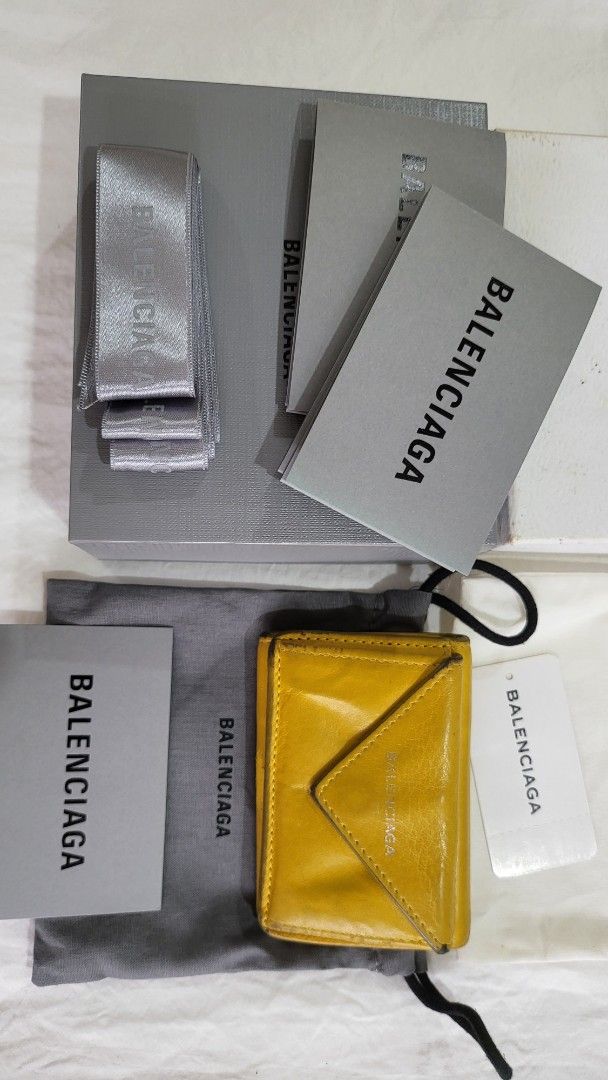 Bundle Balenciaga Envelope Wallet (Category: Luxury Bags & Wallets) located in Quezon City. Submitted by bonching (Listing ID 1399509839, Image 3). Description: - Authentic Balenciaga Trifold wallet - Available in white and yellow - Includes original box, dust bag, and cards - Compact design with snap closure - Comes with all original packaging and accessories - Perfect for everyday use 3800 each.
