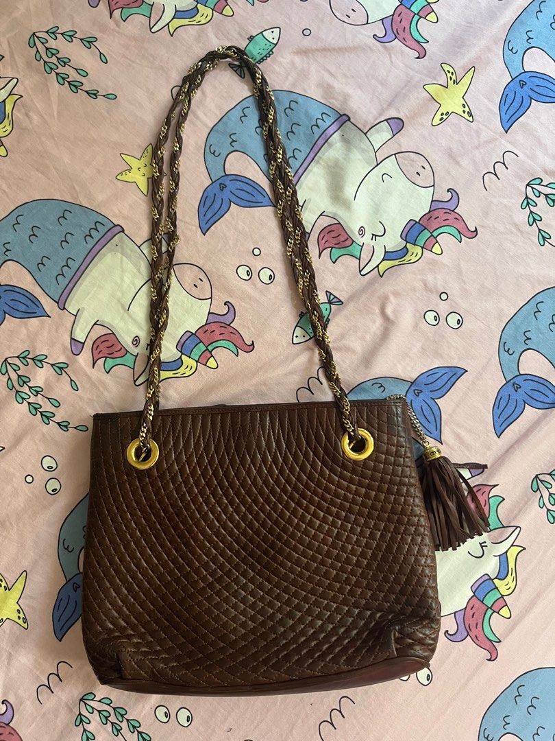 Bally Quilted Leather Shoulder Bag (Category: Luxury Bags & Wallets) located in Cebu City. Submitted by 7paws (Listing ID 1399633716, Image 2). Description: - Bally shoulder bag in brown - Quilted leather exterior - Braided chain strap - Features a tassel detail - Gold-tone logo - Multiple interior compartments - Perfect for everyday use.