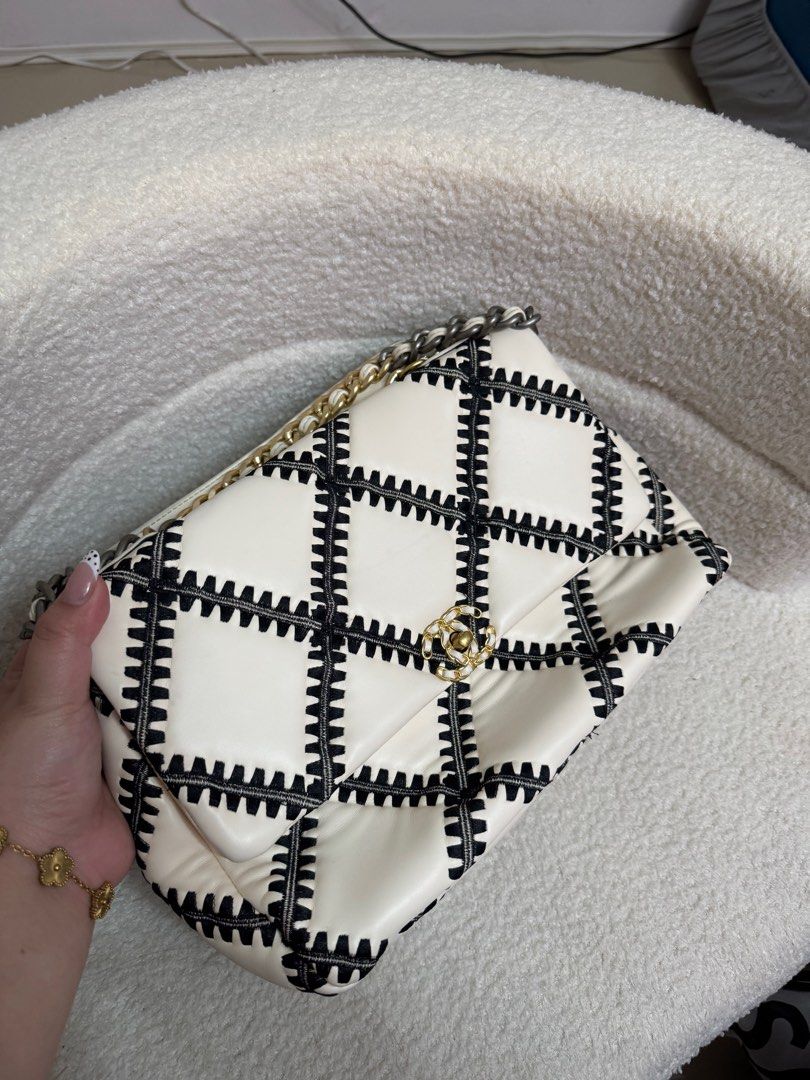Chanel 19 Flap Bag (Category: Luxury Bags & Wallets) located in Manila. Submitted by blairserena (Listing ID 1399551715, Image 2). Description: - Chanel 19 Flap Bag - Black and white stitched design - Mixed gold and silver chain strap - Black interior - Classic Chanel logo - Medium size.