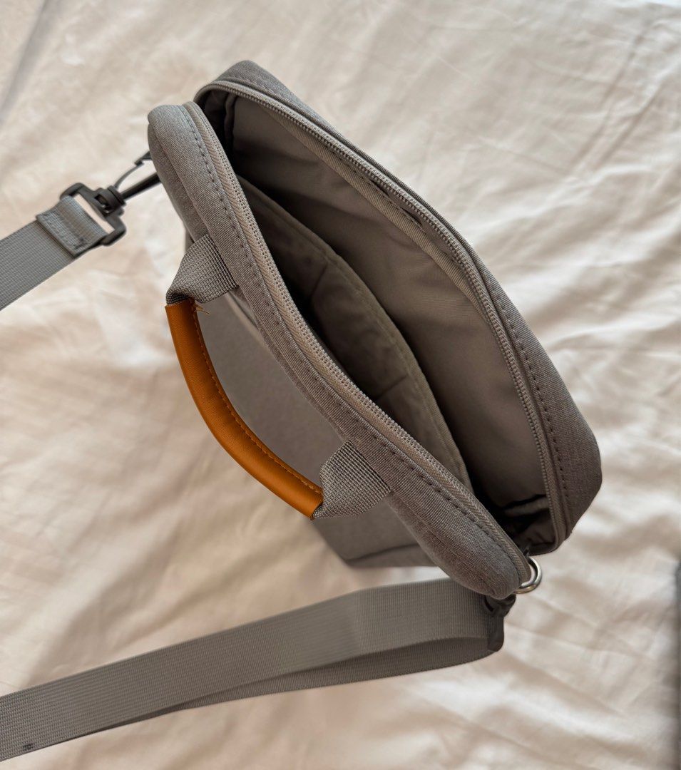 Gray Messenger Bag with Shoulder Strap (Category: Luxury Bags & Wallets) located in Paranaque City. Submitted by somegooodstuff (Listing ID 1399595139, Image 3). Description: - Gray messenger bag - Main compartment and front zipper pocket - Adjustable shoulder strap - Top handle with brown leather accent - Durable, textured fabric - Interior with multiple compartments Laptop bag Tablet bag.