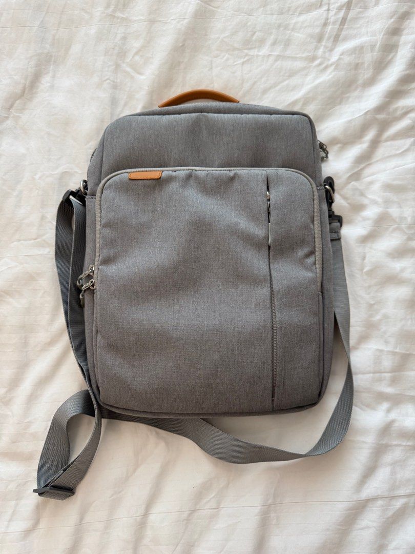Gray Messenger Bag with Shoulder Strap (Category: Luxury Bags & Wallets) located in Paranaque City. Submitted by somegooodstuff (Listing ID 1399595139, Image 1). Description: - Gray messenger bag - Main compartment and front zipper pocket - Adjustable shoulder strap - Top handle with brown leather accent - Durable, textured fabric - Interior with multiple compartments Laptop bag Tablet bag.