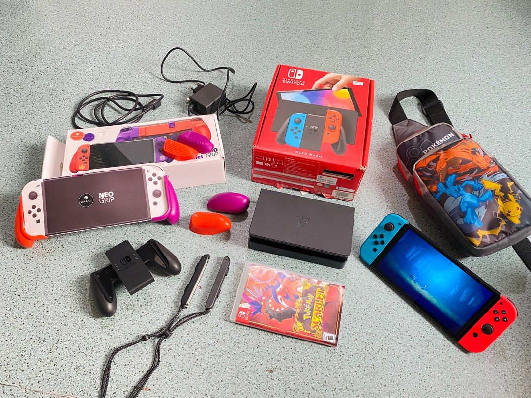 Nintendo Switch OLED Model Bundle (Category: Nintendo) located in Sorsogon. Submitted by m.espedido (Listing ID 1399460389, Image 1). Description: - Nintendo Switch OLED Model with red and blue Joy-Cons - Includes Pokemon Scarlet game - Pokemon-themed carrying case - Charging dock included - Comes with a Neo Grip - Includes Joy-Con straps - Original box included.
