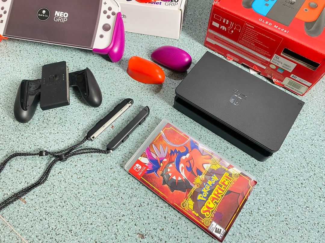 Nintendo Switch OLED Model Bundle (Category: Nintendo) located in Sorsogon. Submitted by m.espedido (Listing ID 1399460389, Image 3). Description: - Nintendo Switch OLED Model with red and blue Joy-Cons - Includes Pokemon Scarlet game - Pokemon-themed carrying case - Charging dock included - Comes with a Neo Grip - Includes Joy-Con straps - Original box included.
