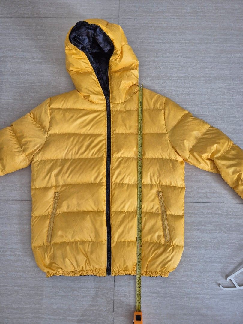 Winter down jacket, reversible (Category: Coats, Jackets and Outerwear) located in Singapore. Submitted by instadeals (Listing ID 1399531849, Image 4). Description: Winter down jacket Good condition, lightly used Reversible design: camo print / yellow With non detachable hood Two side pockets Measurements in images Length 70cm Pit to pit 60cm.