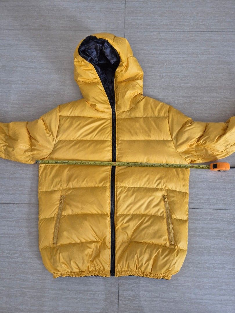 Winter down jacket, reversible (Category: Coats, Jackets and Outerwear) located in Singapore. Submitted by instadeals (Listing ID 1399531849, Image 3). Description: Winter down jacket Good condition, lightly used Reversible design: camo print / yellow With non detachable hood Two side pockets Measurements in images Length 70cm Pit to pit 60cm.