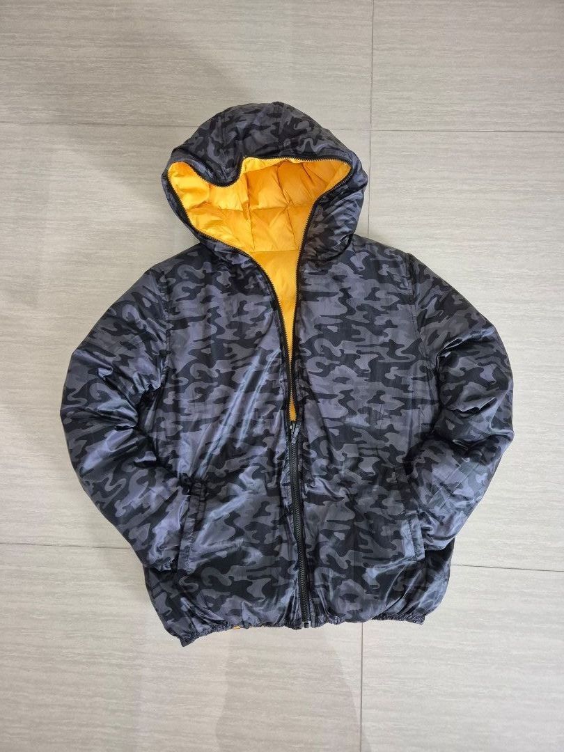 Winter down jacket, reversible (Category: Coats, Jackets and Outerwear) located in Singapore. Submitted by instadeals (Listing ID 1399531849, Image 1). Description: Winter down jacket Good condition, lightly used Reversible design: camo print / yellow With non detachable hood Two side pockets Measurements in images Length 70cm Pit to pit 60cm.