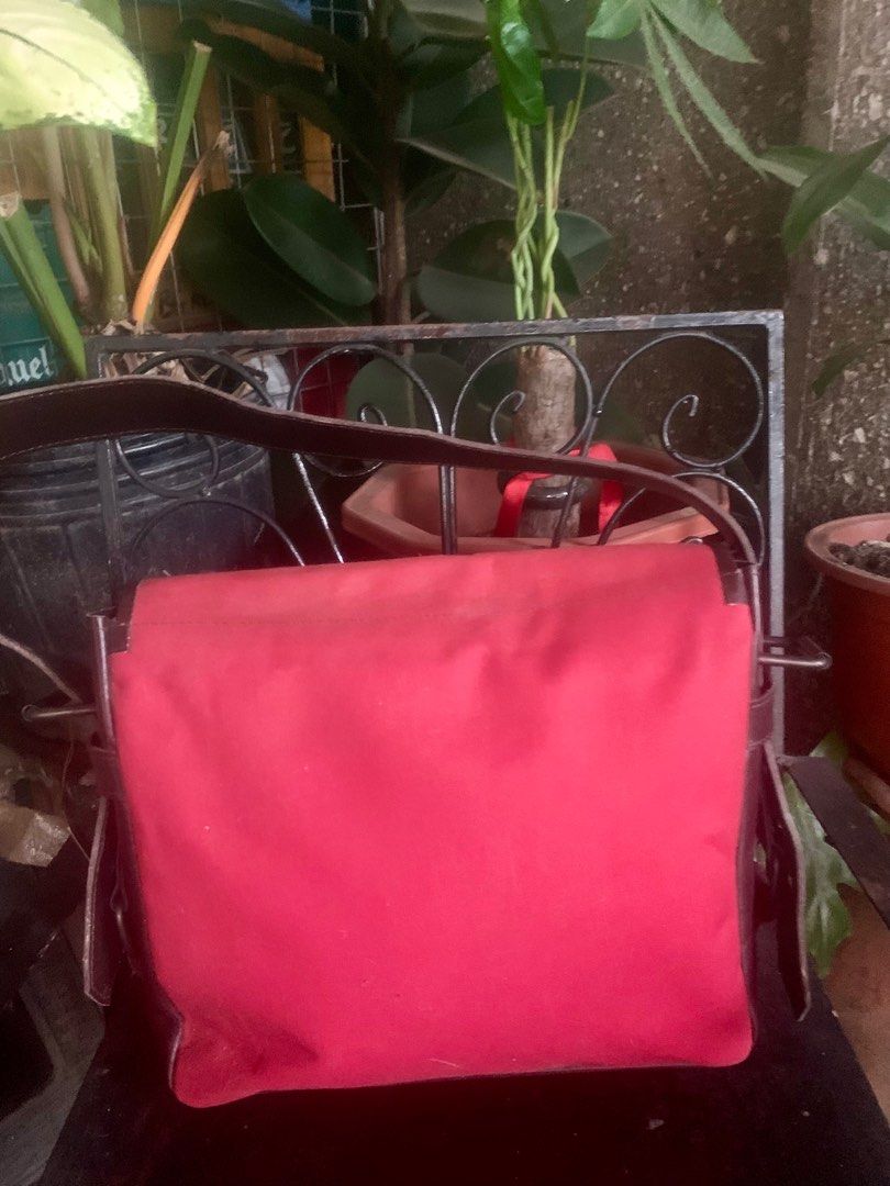YSL Red Shoulder Bag (Category: Luxury Bags & Wallets) located in General Santos City (Dadiangas). Submitted by mj_luxuries_bags_and_stuff (Listing ID 1399553338, Image 2). Description: - Authentic YSL shoulder bag from Japan Surplus - Color: Red and Brown - Features a flap closure with buckle details - Interior: Red with zipper closure - Includes YSL tag - Long shoulder strap - Zipper with YKK logo.
