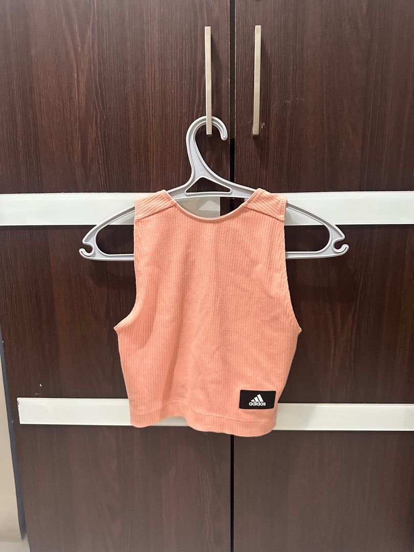[ADIDAS] Crop Top with Zipper (Category: Others Tops) located in Manila. Submitted by abcdeclutter__ (Listing ID 1399727287, Image 1). Description: - Adidas crop top in peach - Ribbed texture - Small Adidas logo - Low scoop back - White stripes on sides - Front zipper closure - Stylish and comfortable.