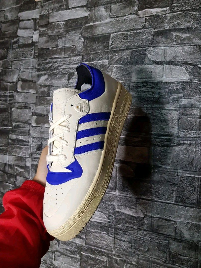 Adidas Rivalry 86 Low 002 Sneakers (Category: Sneakers) located in Caloocan City. Submitted by raffaellosanzio (Listing ID 1399678486, Image 3). Description: - Adidas Rivalry 86 Low sneakers - Color: Cream and Blue - Features the iconic Adidas three stripes - Size: US 10, UK 9.5, EUR 44, 280 CM - Comes with original tags and box - Original Price: PHP 5,800.00.