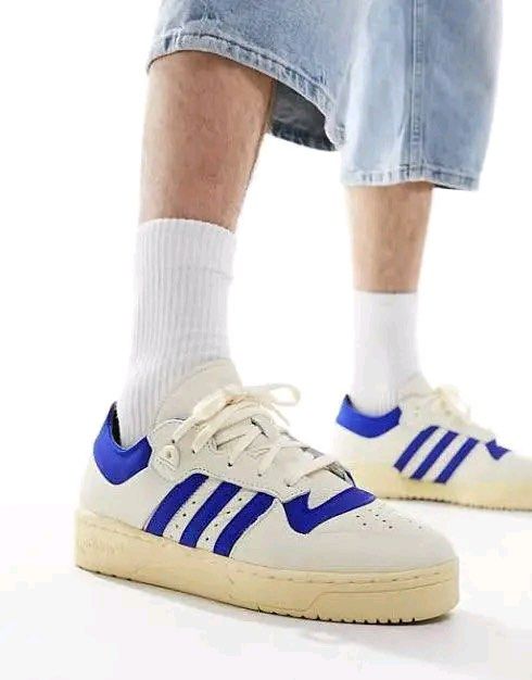 Adidas Rivalry 86 Low 002 Sneakers (Category: Sneakers) located in Caloocan City. Submitted by raffaellosanzio (Listing ID 1399678486, Image 1). Description: - Adidas Rivalry 86 Low sneakers - Color: Cream and Blue - Features the iconic Adidas three stripes - Size: US 10, UK 9.5, EUR 44, 280 CM - Comes with original tags and box - Original Price: PHP 5,800.00.
