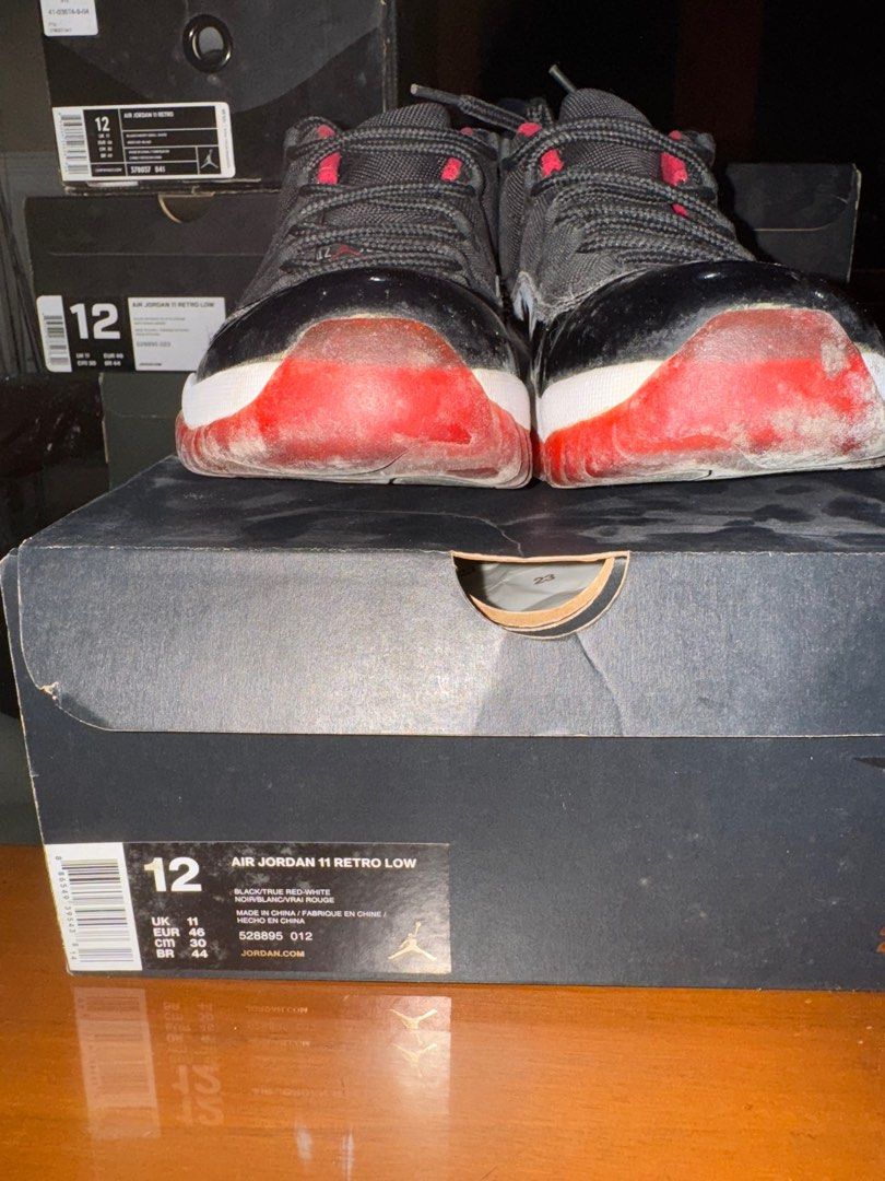 Air Jordan 11 Retro Low Black/True Red (Category: Sneakers) located in Quezon City. Submitted by tinylee60 (Listing ID 1399764449, Image 1). Description: - Air Jordan 11 Retro Low - Color: Black and Red - Size: 12 - Condition: Used (signs of wear on sole and upper) - Includes original box.