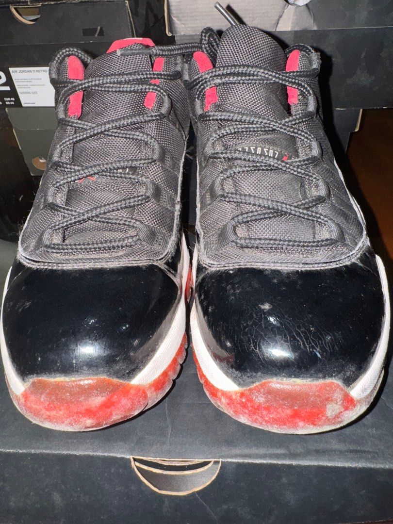 Air Jordan 11 Retro Low Black/True Red (Category: Sneakers) located in Quezon City. Submitted by tinylee60 (Listing ID 1399764449, Image 2). Description: - Air Jordan 11 Retro Low - Color: Black and Red - Size: 12 - Condition: Used (signs of wear on sole and upper) - Includes original box.