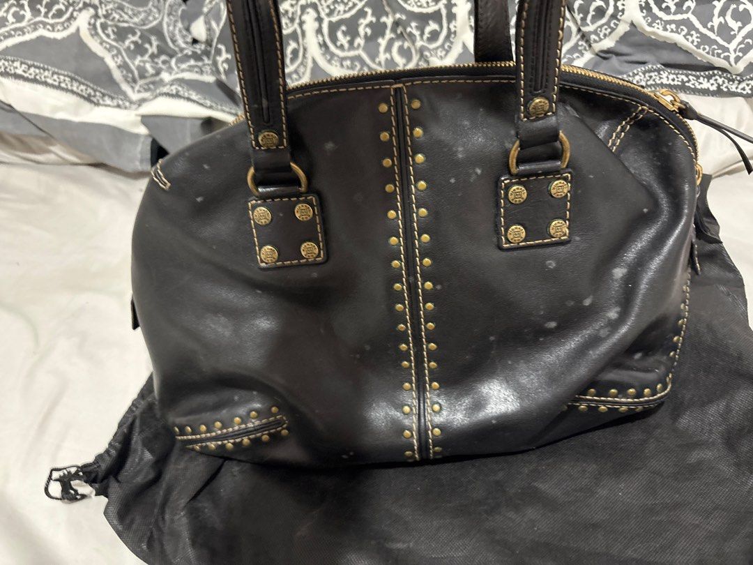 Black Leather Handbag with Studs (Category: Luxury Bags & Wallets) located in Las Pinas. Submitted by ochey20 (Listing ID 1399754180, Image 1). Description: - Authentic Original Michael kors hand /shoulder bag -Black leather handbag - Gold-colored studs and stitching - Double handles - Zip closure - Light-colored interior lining - Interior zip pocket - Includes dust bag - Minor white spots on exterior - it’s just so dirty needs to be clean .