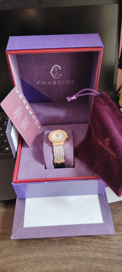 Charriol St. Tropez Watch (Category: Women's Watches) located in Mandaluyong City. Submitted by trisha_001 (Listing ID 1399649349, Image 2). Description: - Charriol St. Tropez watch - Gold-tone bezel with diamond-like embellishment - Silver and gold cable strap - Includes original box and papers - Comes with a velvet pouch - Mother-of-pearl watch face - Visible Charriol logo on the back.