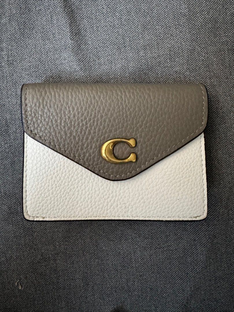 Coach Envelope Card Case Wallet (Category: Luxury Bags & Wallets) located in Makati City. Submitted by jamyyogi (Listing ID 1399652441, Image 1). Description: - Coach card case wallet - Two-tone grey and white design - Gold-tone 'C' logo - Snap closure - Interior card slots - Bill compartment - Made of textured leather.