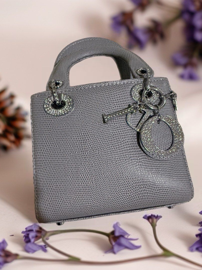 Dior Lady Dior Mini Bag (Category: Luxury Bags & Wallets) located in Quezon City. Submitted by syogrl (Listing ID 1399813406, Image 1). Description: - Mini Lady Dior handbag - Textured grey material - Iconic Dior charms - Silver-tone hardware - Structured shape - Compact size - Perfect for essentials - Sparkling embellishments on charms and handle attachments - logo / brand inside (no serial) - with long strap - used once in wedding.