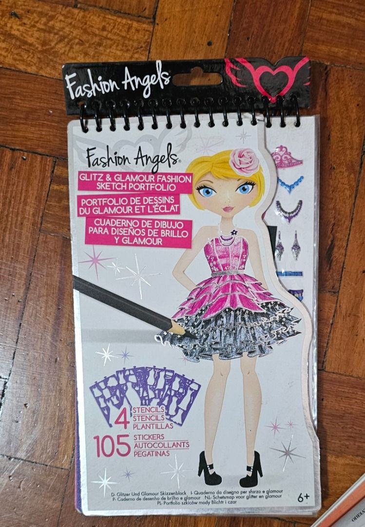Fashion Sketch Portfolio (Category: Craft Supplies & Tools) located in Manila. Submitted by bettyb00p (Listing ID 1399708756, Image 1). Description: - Fashion Angels Glitz & Glamour Sketch Portfolio - Includes 4 stencils - Features 105 stickers - Perfect for creating glittery and glamorous fashion sketches - Spiral bound for easy use.