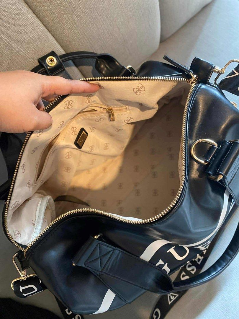 Guess travel bag (Category: Luxury Bags & Wallets) located in San Fernando. Submitted by smjhsmnlzcn (Listing ID 1399673894, Image 3). Description: Guess travel bag with sling strap.