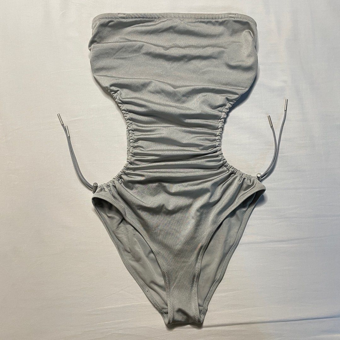 H&M Silver Cut-Out Swimsuit Size 6 (Category: Bikinis & Swimsuits) located in Cabanatuan. Submitted by goldengem-finds (Listing ID 1399725441, Image 2). Description: - H&M silver swimsuit - Size 6 - Strapless design - Unique cut-out details - Adjustable drawstring - Made from shiny, smooth fabric - Perfect for beach or pool.