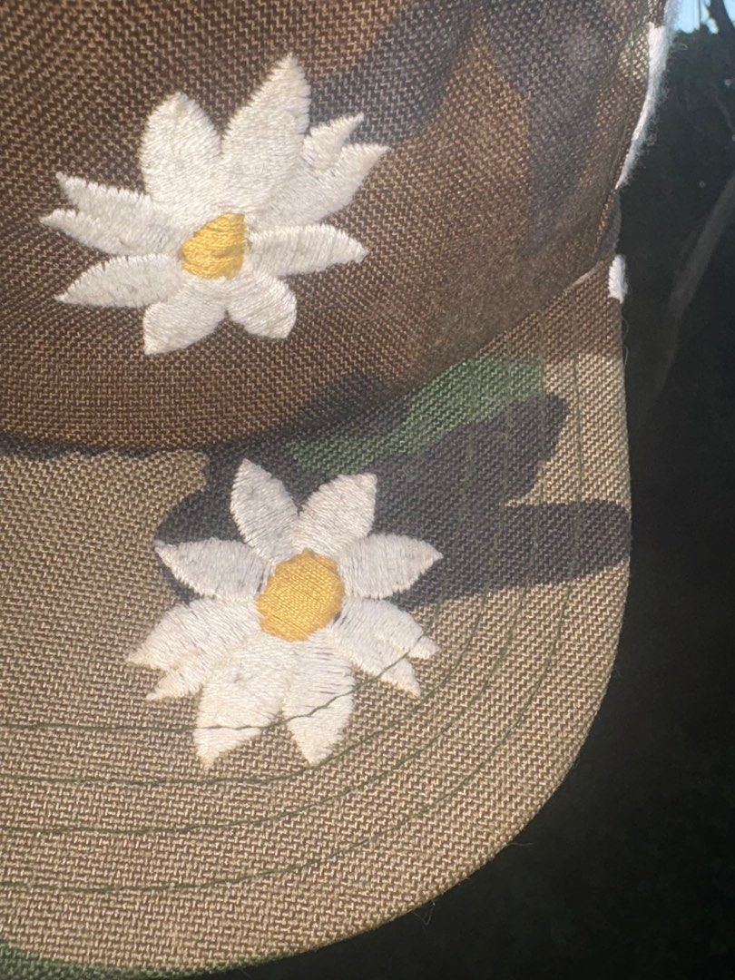Mark McNairy New Amsterdam Camo Daisy Cap (Category: Caps & Hats) located in Quezon City. Submitted by sssourceee (Listing ID 1399734589, Image 2). Description: ORIGINAL MARK MCNAIRY VINTAGE DAISY CAMO HAT - Camouflage pattern cap - Features embroidered white daisy flowers - Made in the USA - Adjustable fit - One size fits most - Brand: "Mark McNairy" - Like new with tags.
