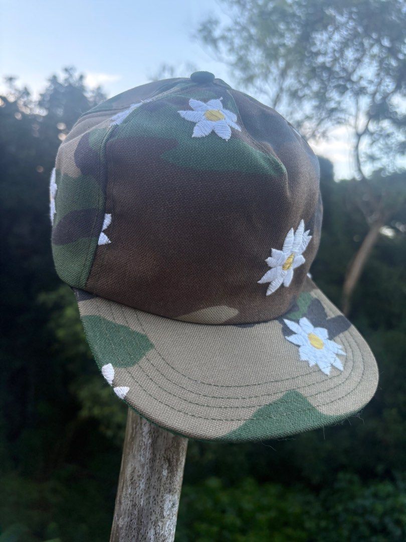 Mark McNairy New Amsterdam Camo Daisy Cap (Category: Caps & Hats) located in Quezon City. Submitted by sssourceee (Listing ID 1399734589, Image 1). Description: ORIGINAL MARK MCNAIRY VINTAGE DAISY CAMO HAT - Camouflage pattern cap - Features embroidered white daisy flowers - Made in the USA - Adjustable fit - One size fits most - Brand: "Mark McNairy" - Like new with tags.