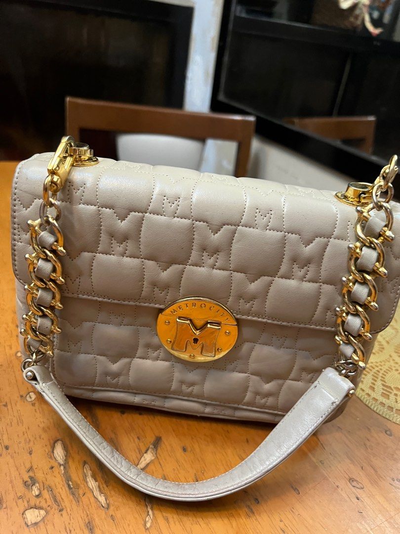 Metrocity Quilted Shoulder Bag (Category: Luxury Bags & Wallets) located in Antipolo. Submitted by blessed.aacmc (Listing ID 1399824073, Image 1). Description: Metrocity shoulder bag - Quilted design with brand logo - Gold chain strap - Flap closure - Multiple interior compartments - Neutral color - Gold-toned hardware.
