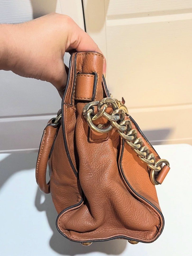 Michael Kors Hamilton Satchel Bag (Category: Luxury Bags & Wallets) located in Agoo. Submitted by grandtree-2c14 (Listing ID 1399651853, Image 3). Description: - Authentic Michael Kors Hamilton satchel bag - Brown leather exterior - Gold-tone hardware - Top handle and detachable shoulder strap - Signature MK fabric lining - Multiple interior compartments - MK logo lock closure - Stylish chain detailing.